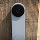 A photo of the battery-powered doorbell affixed to a plank of wood